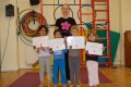 Lil' Buds proudly showing their Grade One certificates and badges after achieving the grade in the Blossom Yoga syllabus