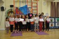 Lil' Buds proudly showing their Grade Two and Three certificates and badges after achieving the grades in the Blossom Yoga syllabus