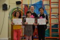 Big Buds proudly showing their Grade Two and Four certificates and button badges after achieving the grades in the Blossom Yoga syllabus