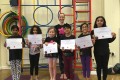 Big Buds proudly showing their Grade One certificates and button badges after achieving the grade in the Blossom Yoga Syllabus