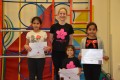 Lil' Buds proudly showing their Grade One certificates and badges after achieving the grade in the Blossom Yoga Syllabus