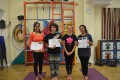 Teen Buds proudly showing their Grade Three and Grade Four certificates and button badges after achieving the grades in the Blossom Yoga Syllabus